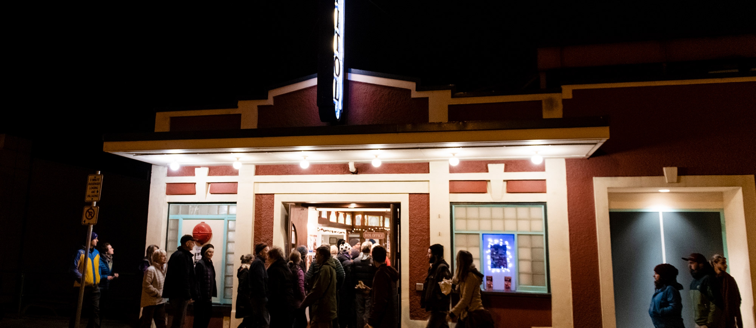 A group of people walking into the Capitol theatre in Nelson, BC