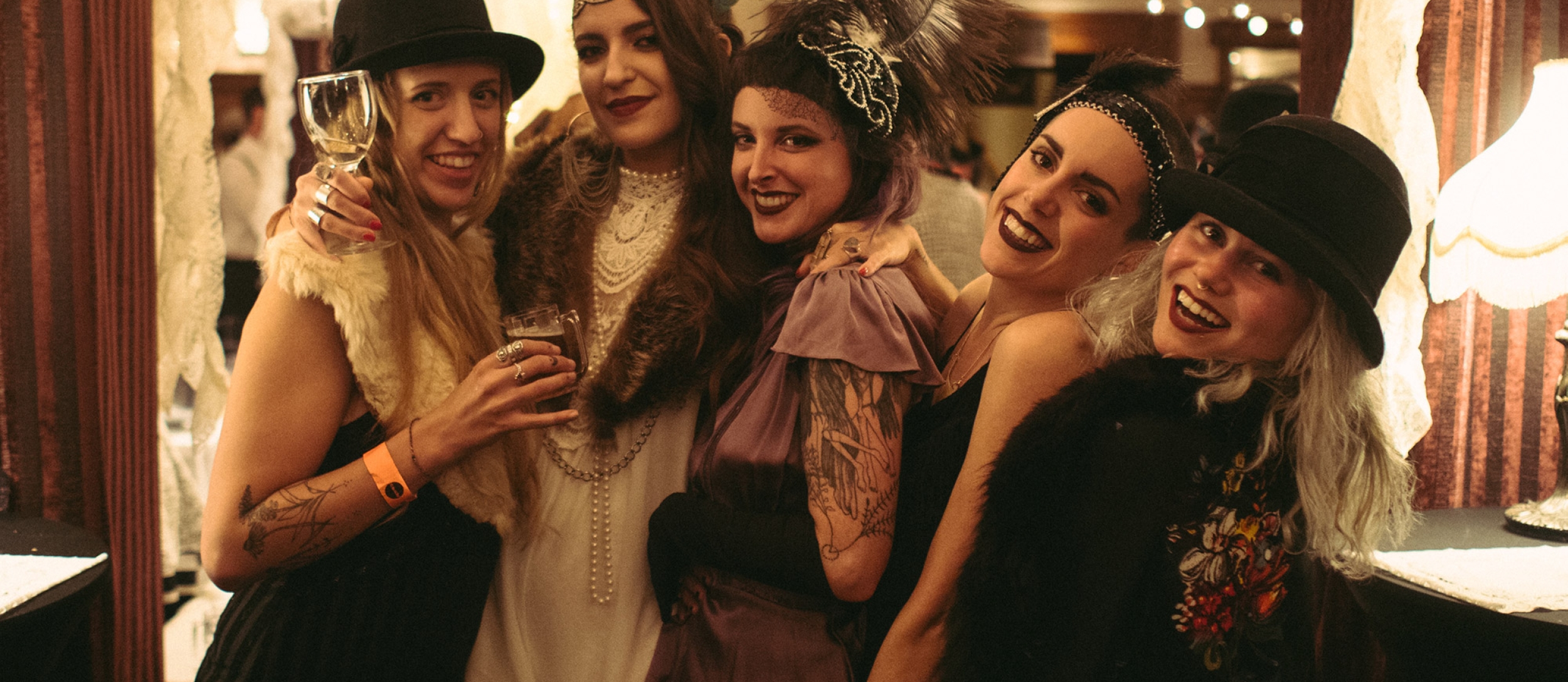 Five women dressed in 20s attire at Grapes & Grains Festival in the Hume Hotel