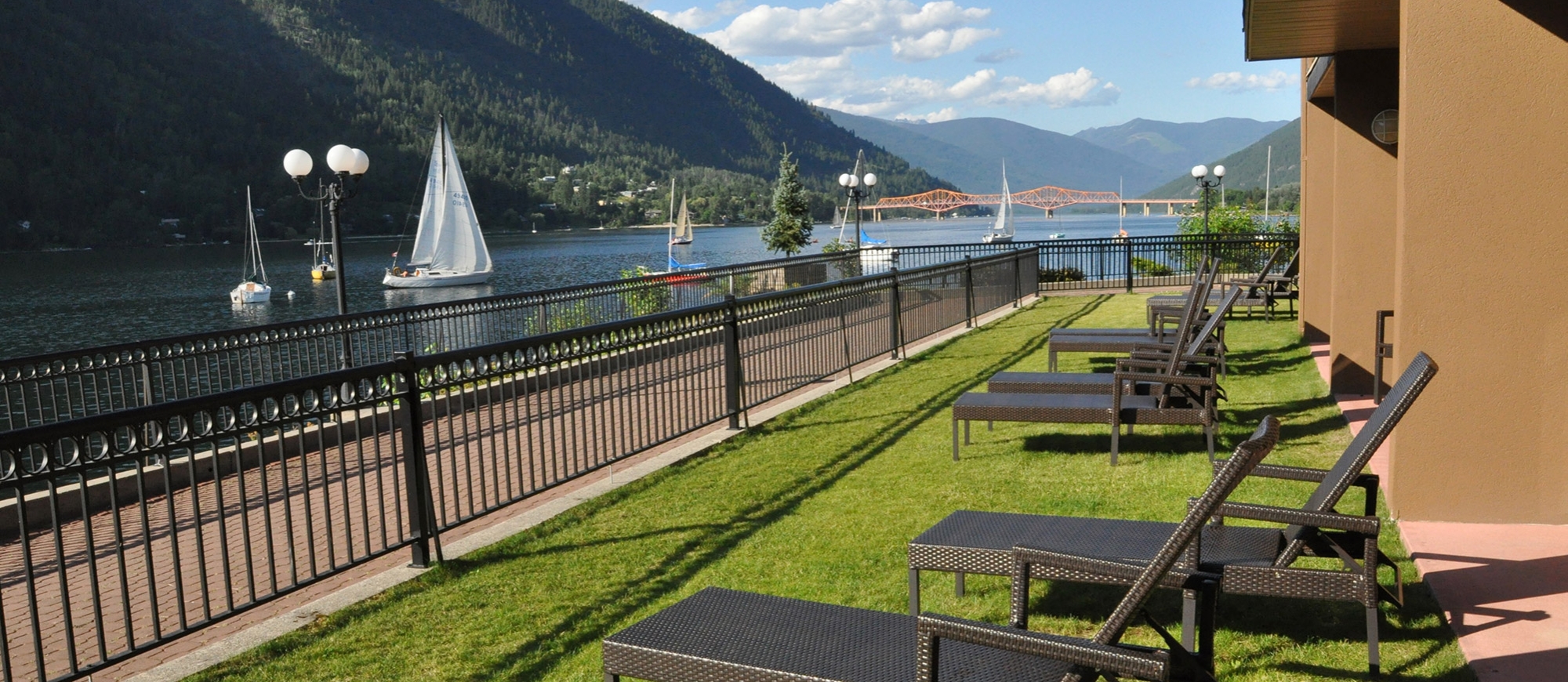 View of the waterfront walk on a sunny day, by the Prestige Lakeside Resort in Nelson BC