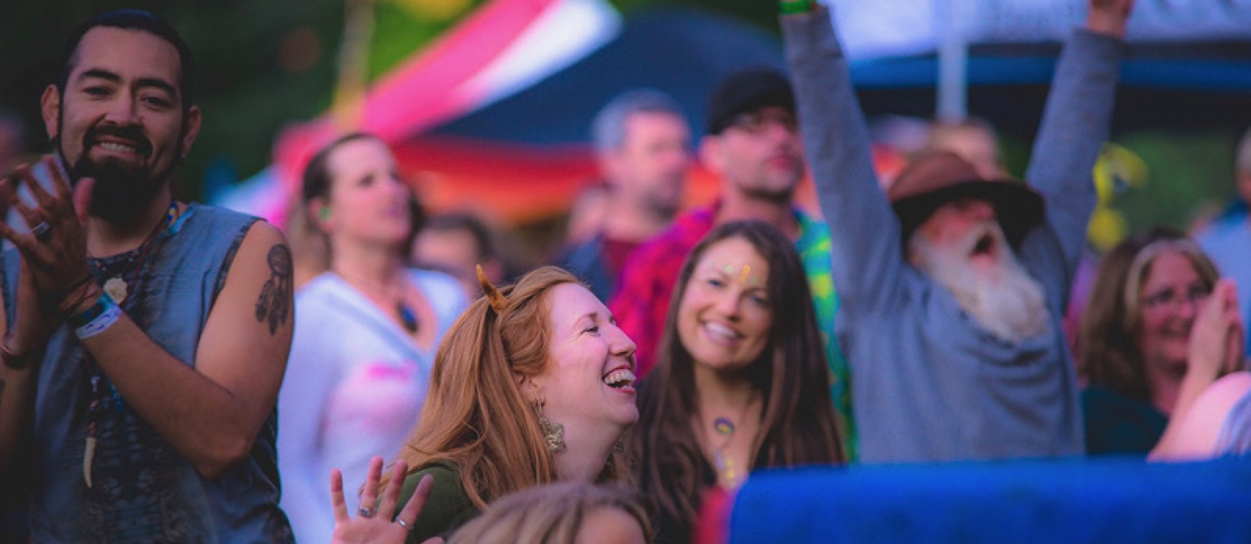 A group of people dancing wearing colourful clothes at Starbelly Jam.