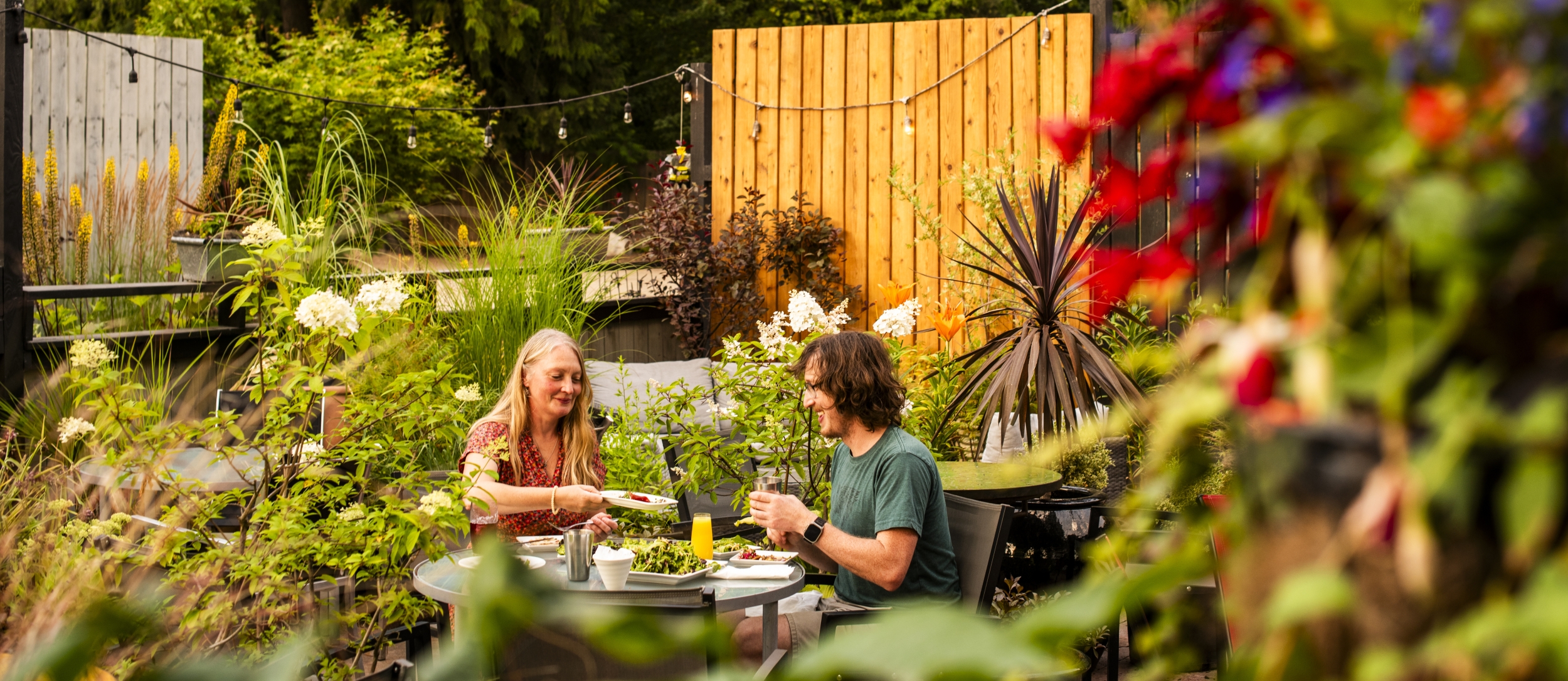 Two people dining on the Black Salt Cafe patio.
