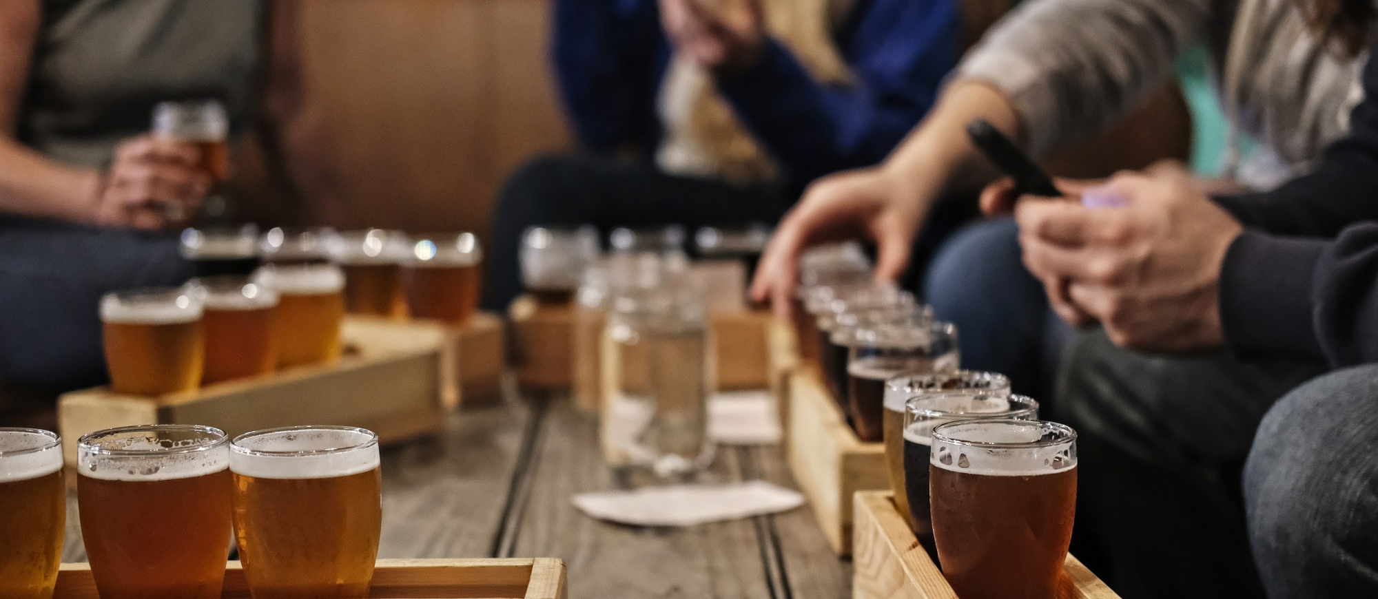 A number of beer flights on a table at Backroads Brewing Co in Nelson, BC.