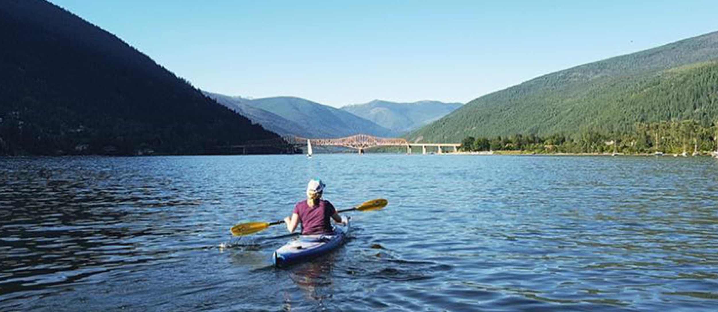 Paddling on Kootenay Lake with the Big Orange Bridge in the background.