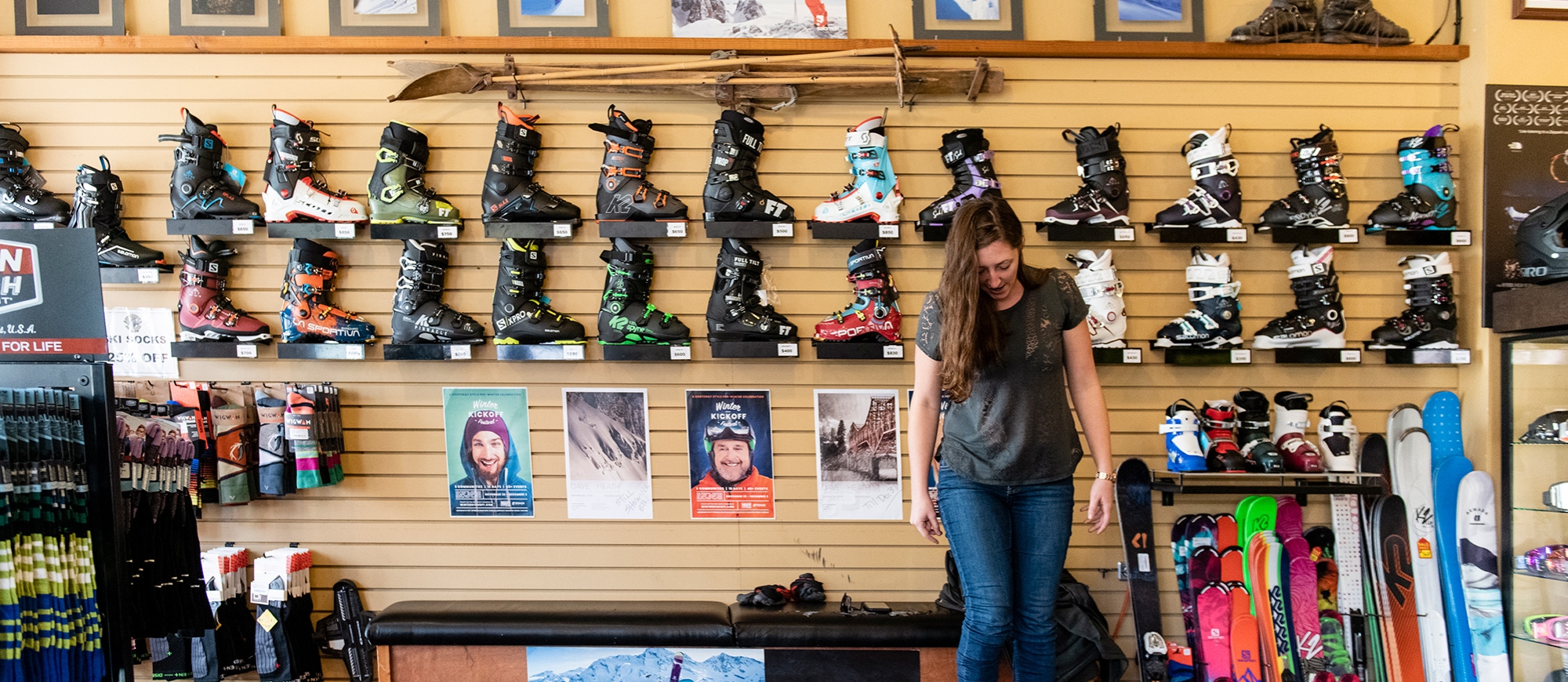 A girl trying on ski boots at Gerick Cycle and Ski in Nelson BC