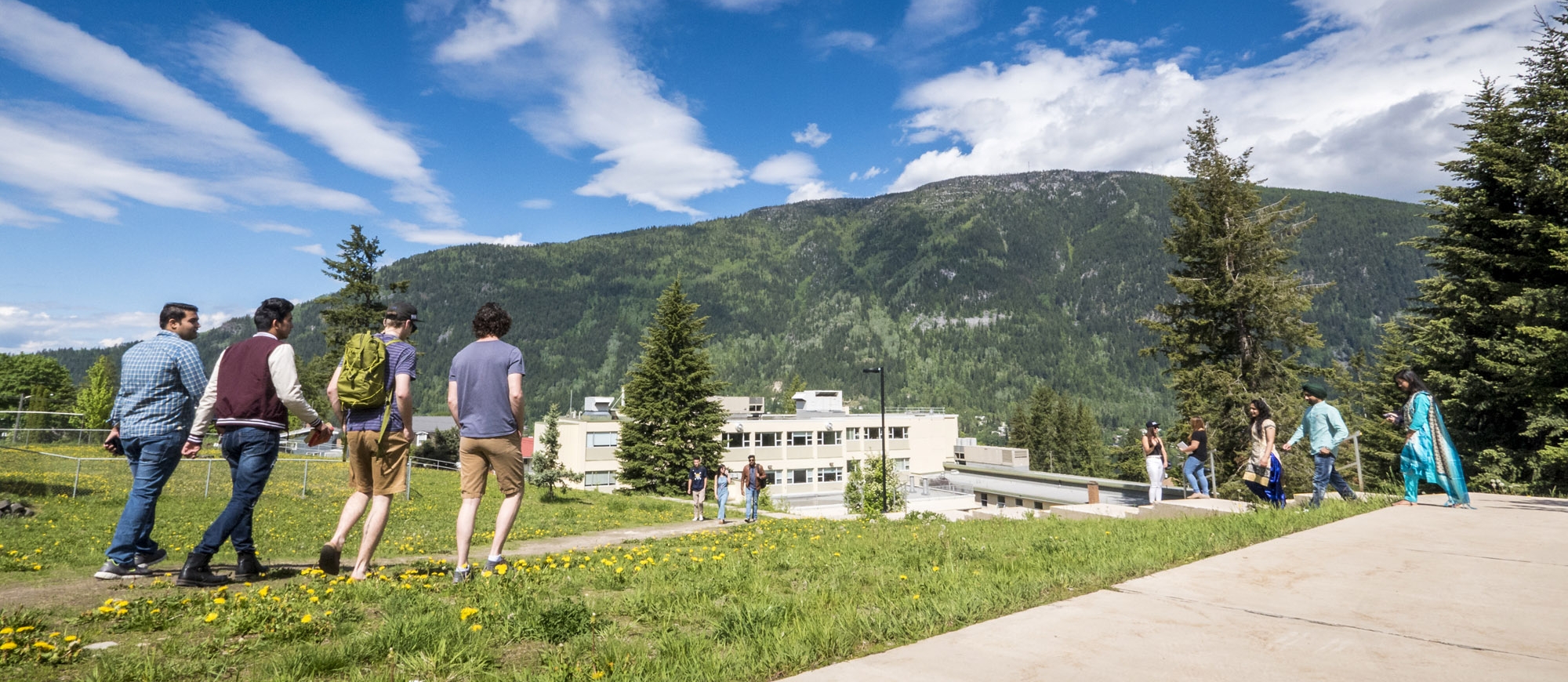 Students walking on the grass at the Selkirk College Tenth Street Campus in Nelson, BC.