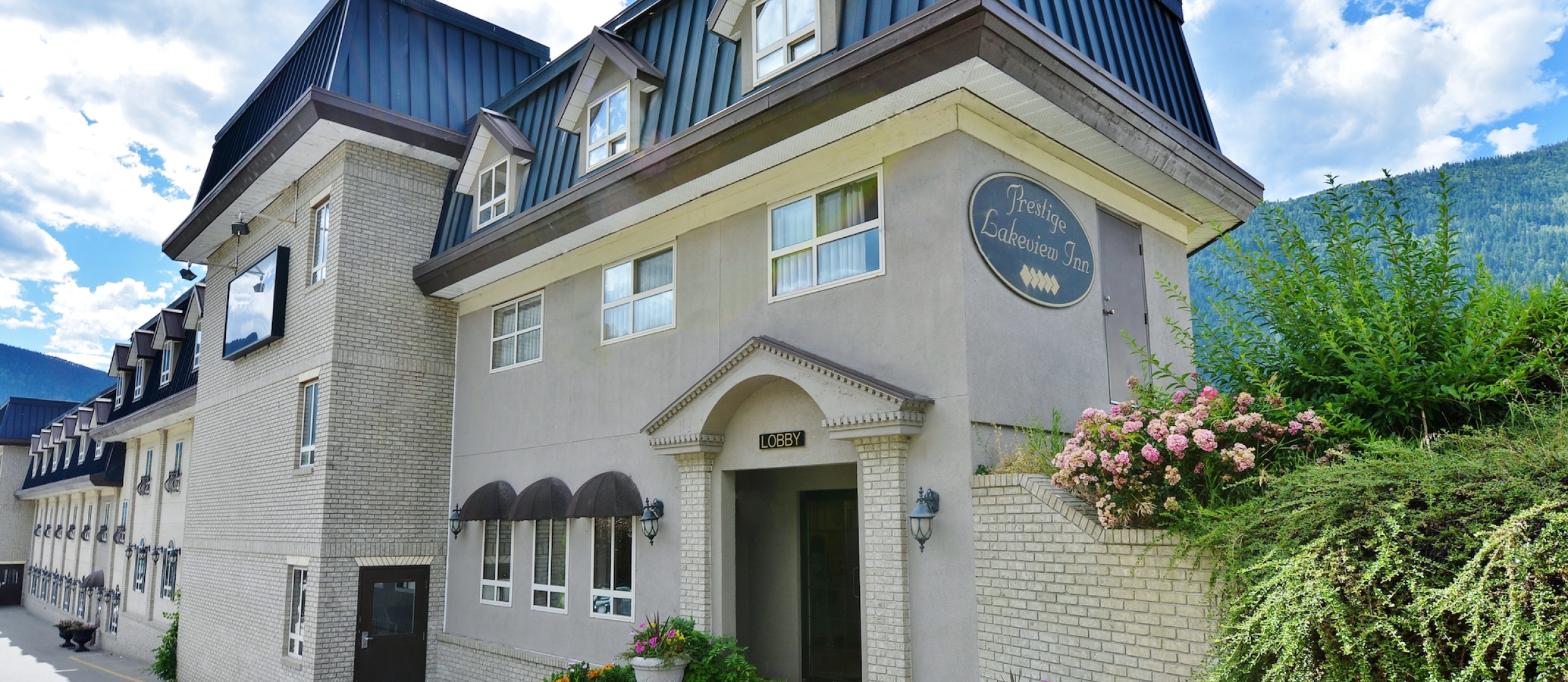 the Prestige Inn building with blue sky in the background