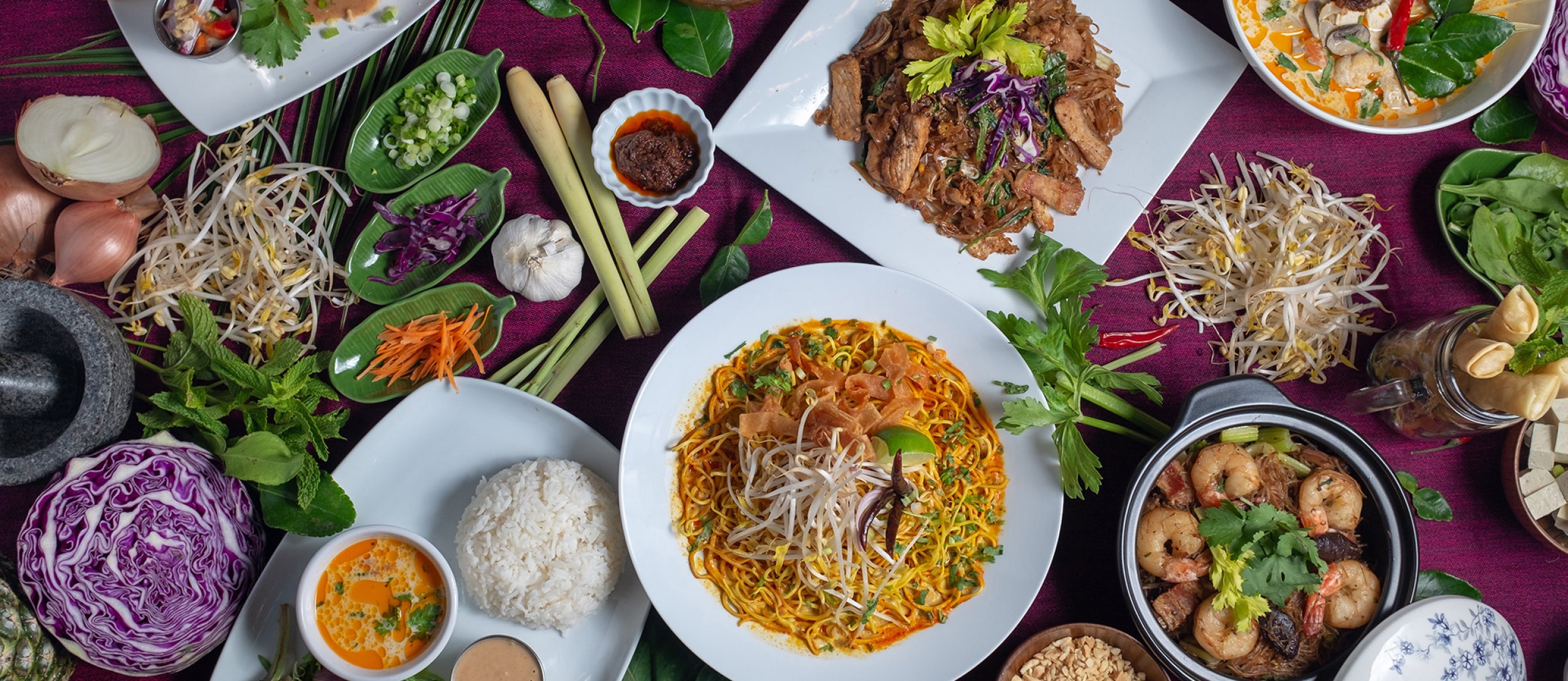 A table with a variety of colourful food at Busaba Thai Cafe in Nelson, BC