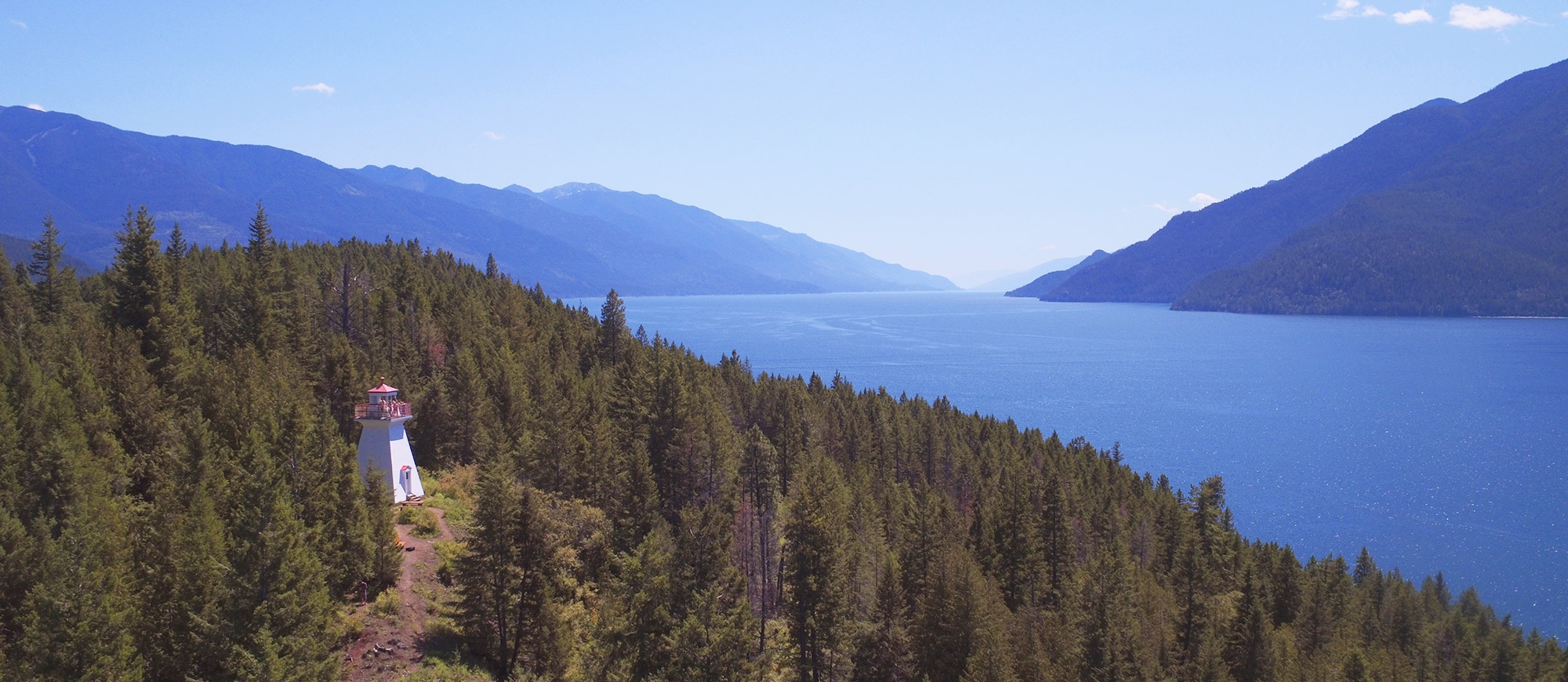 An aerial view of the Pilot Bay Lighthouse and Kootenay Lake, BC