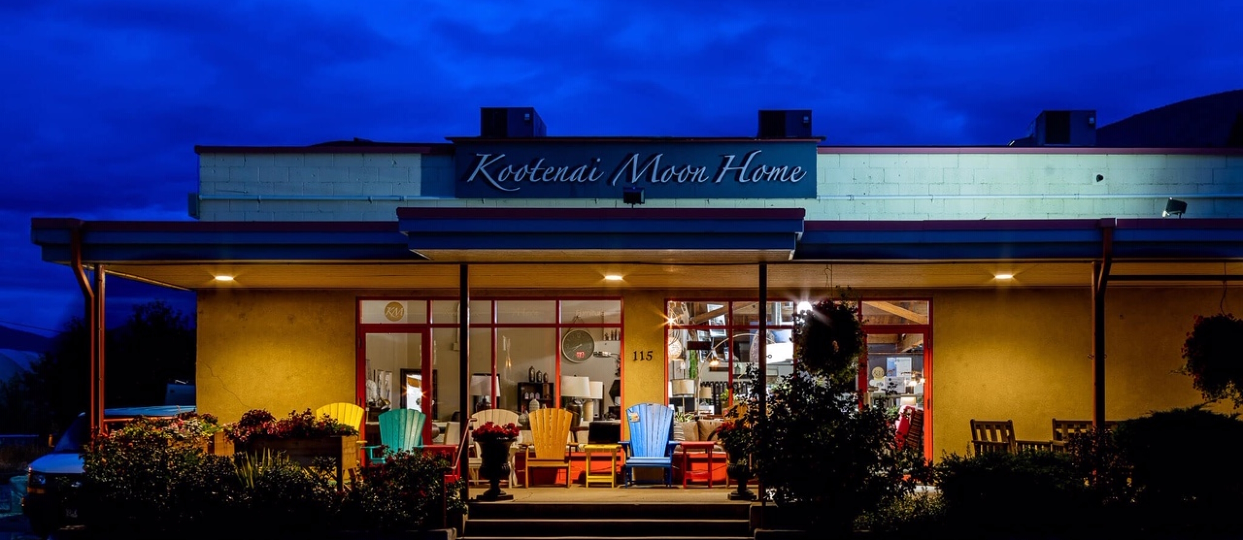 The Kootenai Moon Furniture store lit up at night
