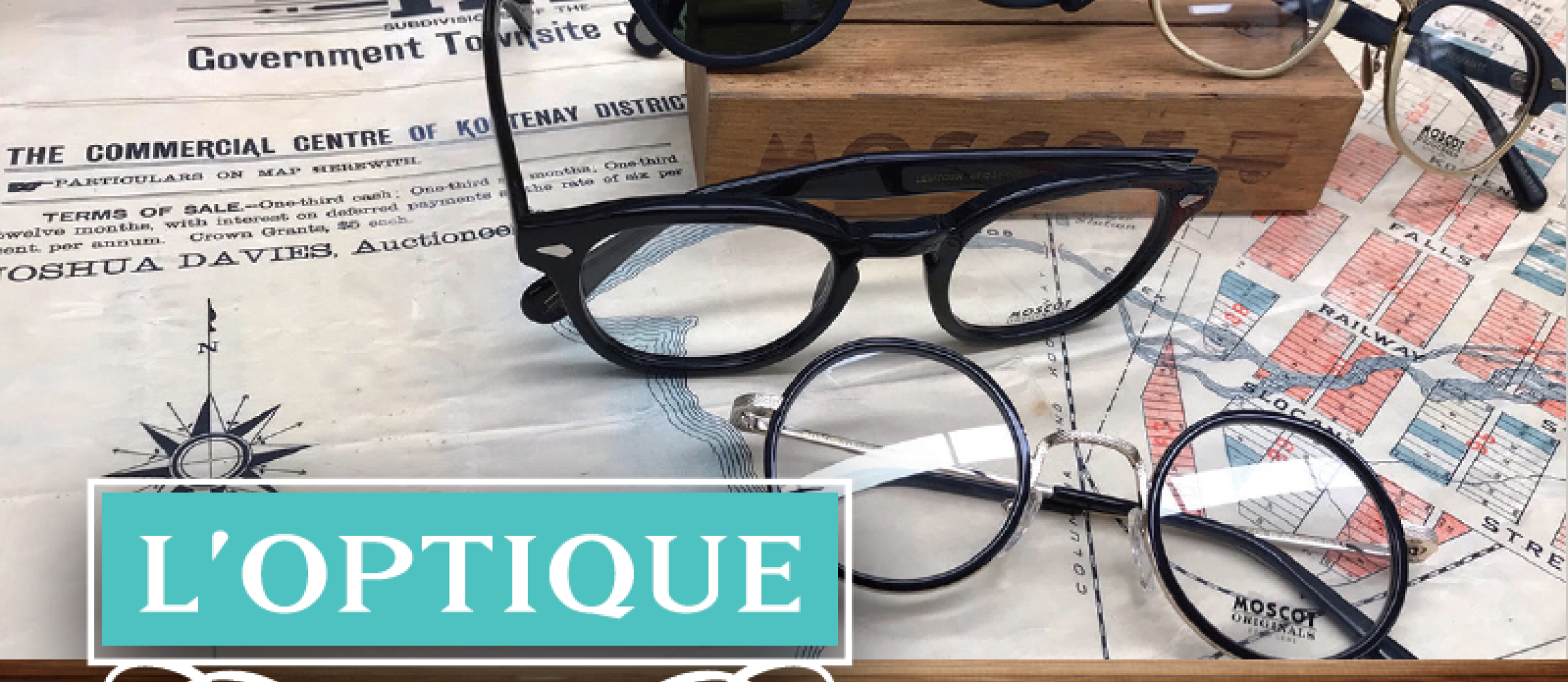 Sunglasses and reading glasses scattered on a table.