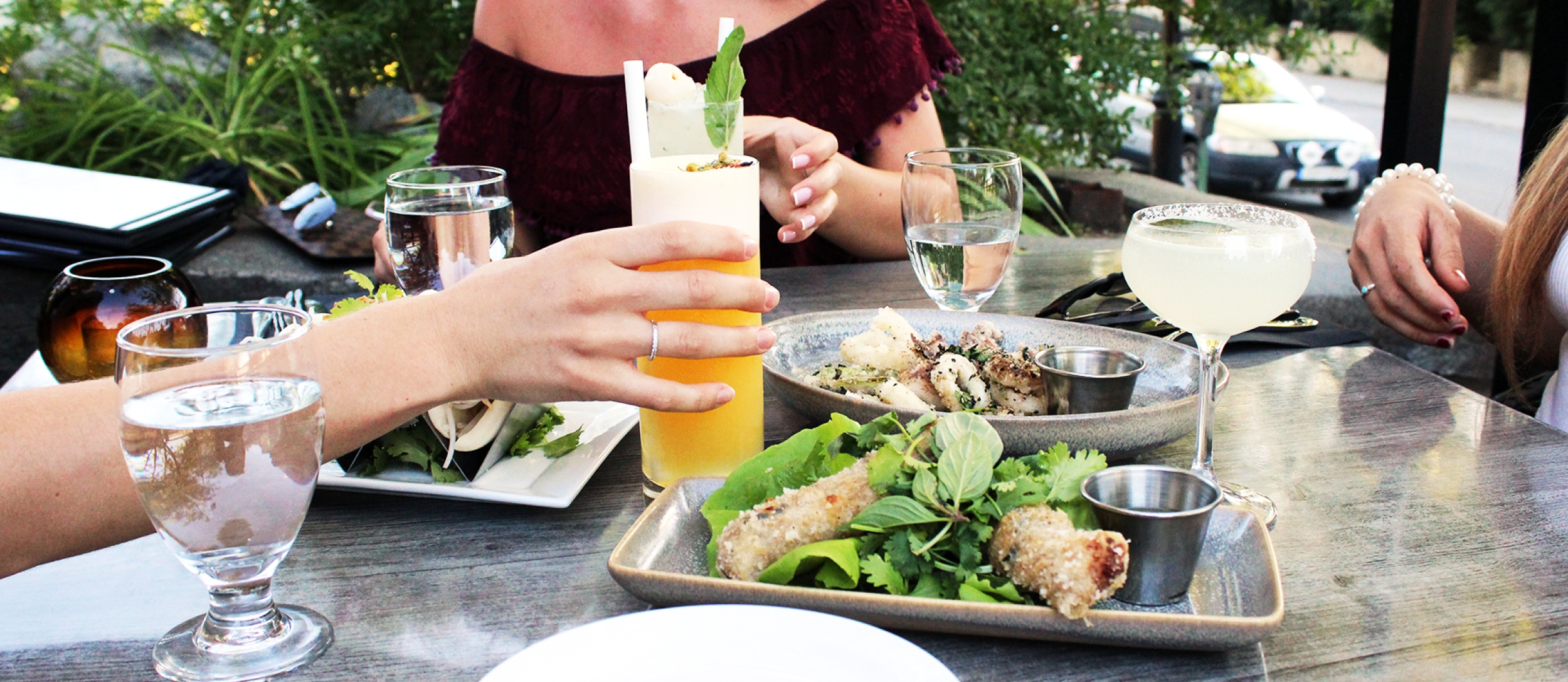 Three people sitting on the patio at Yum Son in Nelson, BC