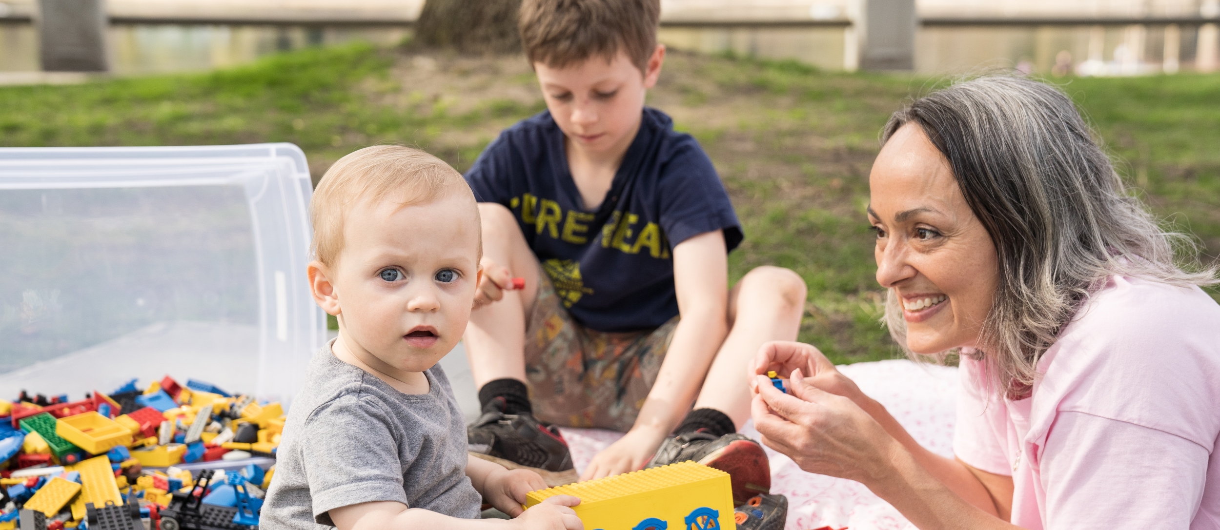 Childcare professional playing with children in Lakeside Park, Nelson BC.