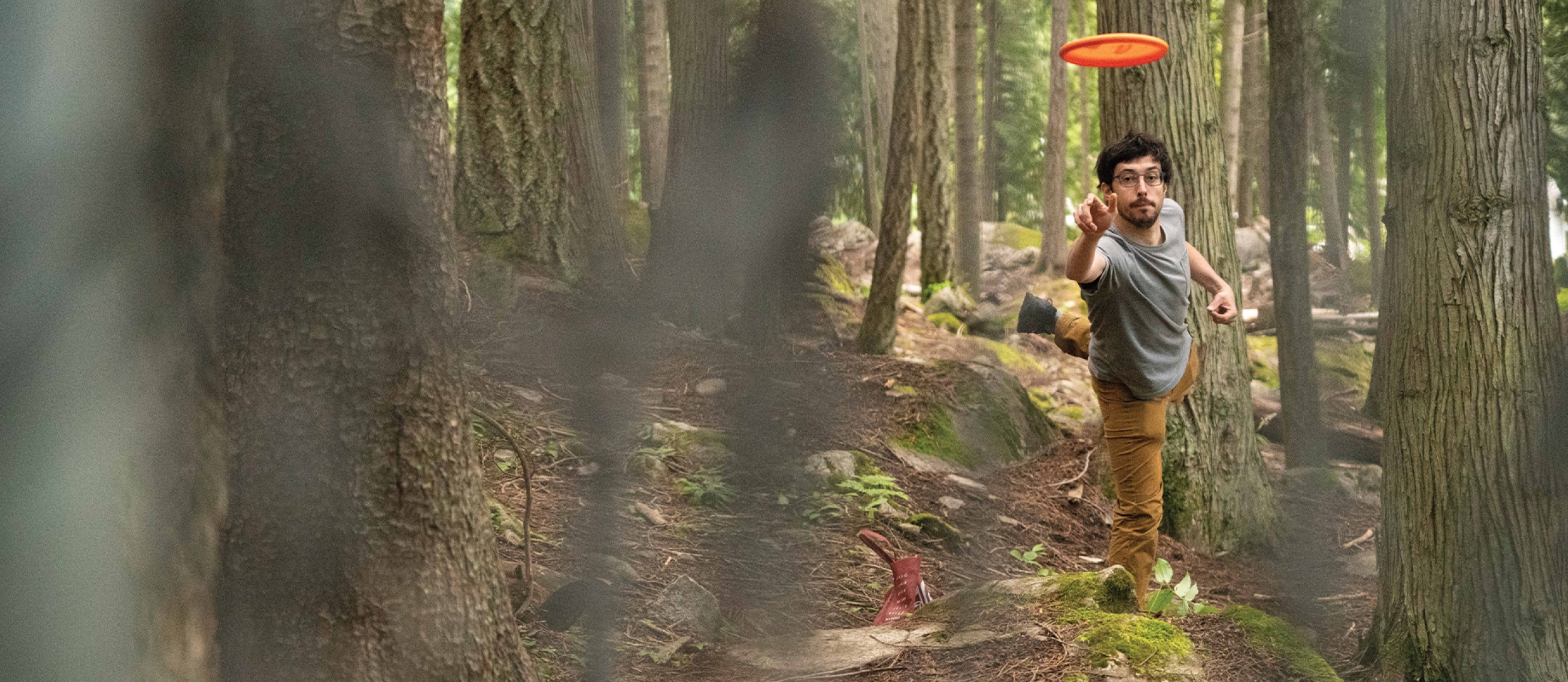 Man playing disc golf at Art Gibbons in Nelson.