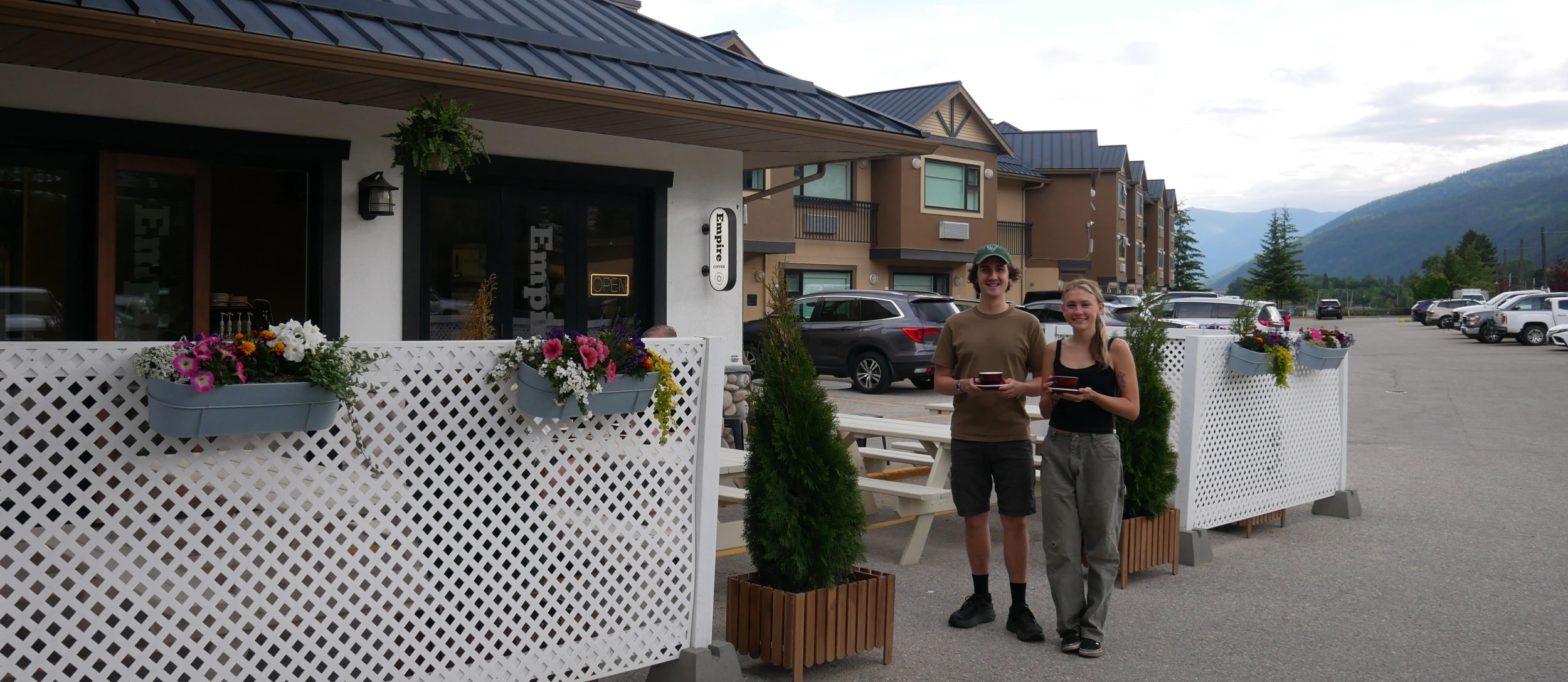 Baristas standing outside Empire Lakeside holding coffees.