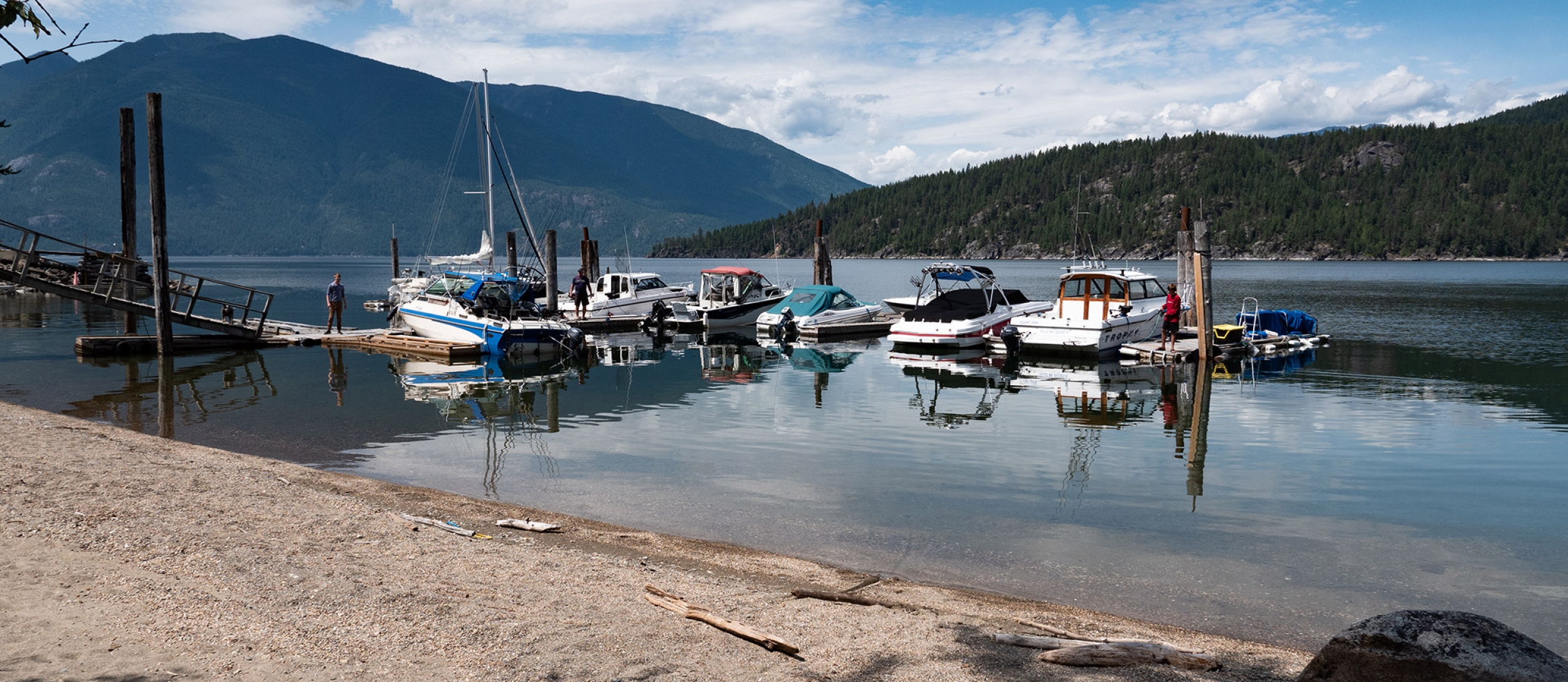 View of the marina with mountains in the background at The Lakeview in Gray Creek near Crawford Bay, BC