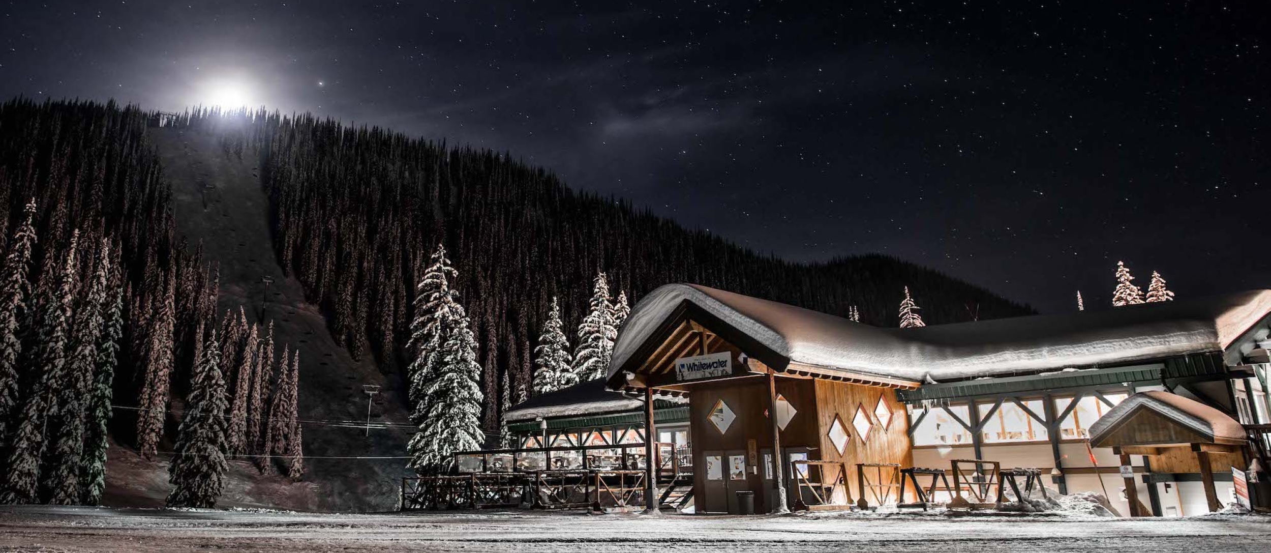 The stars and moonlight light up the Whitewater Ski Resort Lodge at night