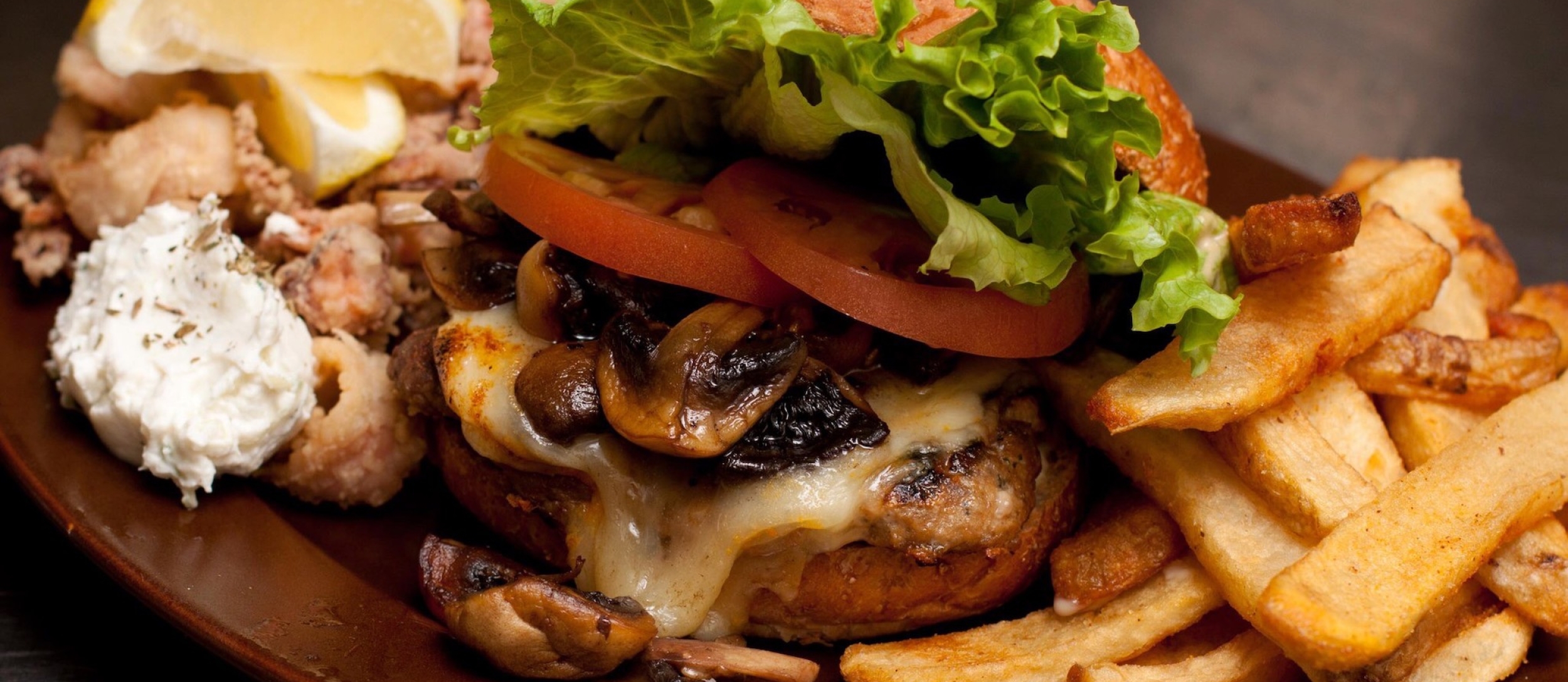 a burger with all of the fixings and fries on the side from Main Street Diner