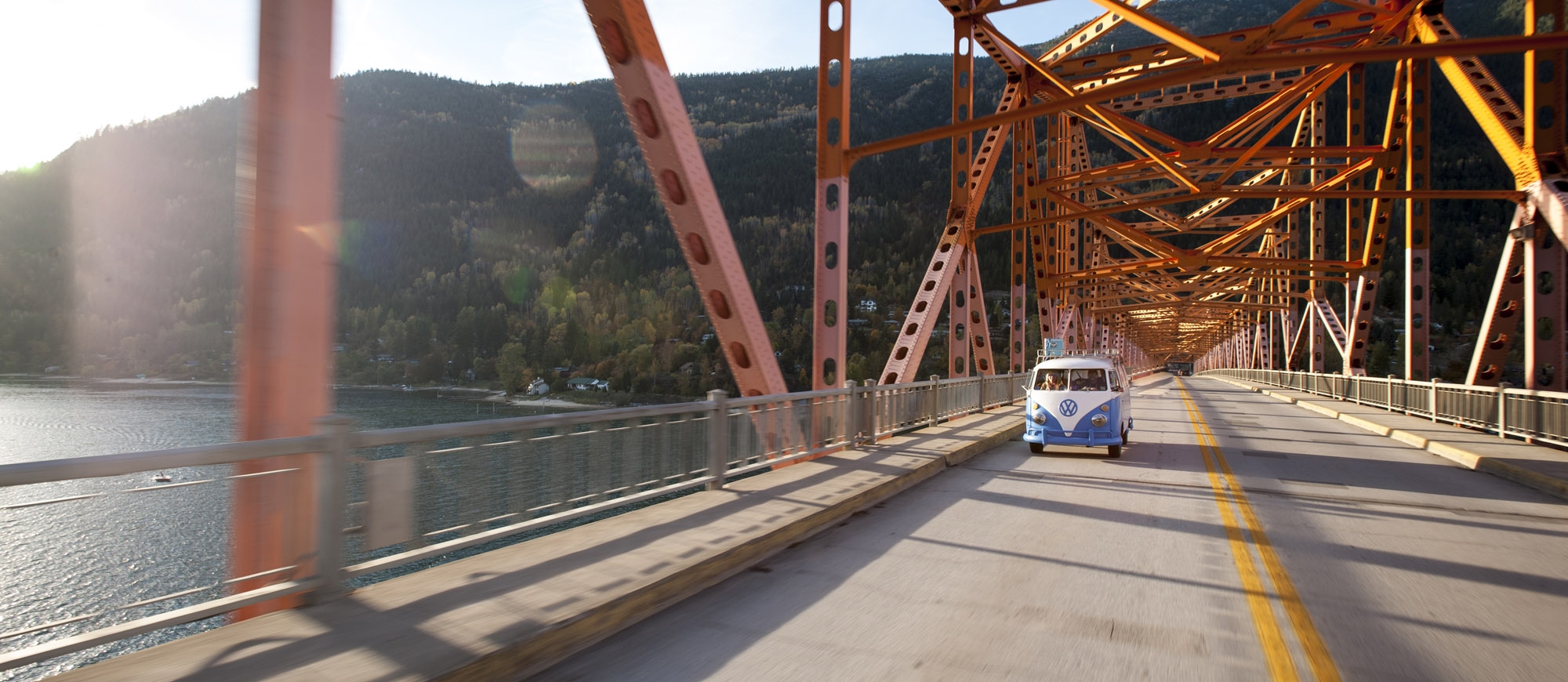 A VW bus driving across the Big Orange Bridge in Nelson, BC. 