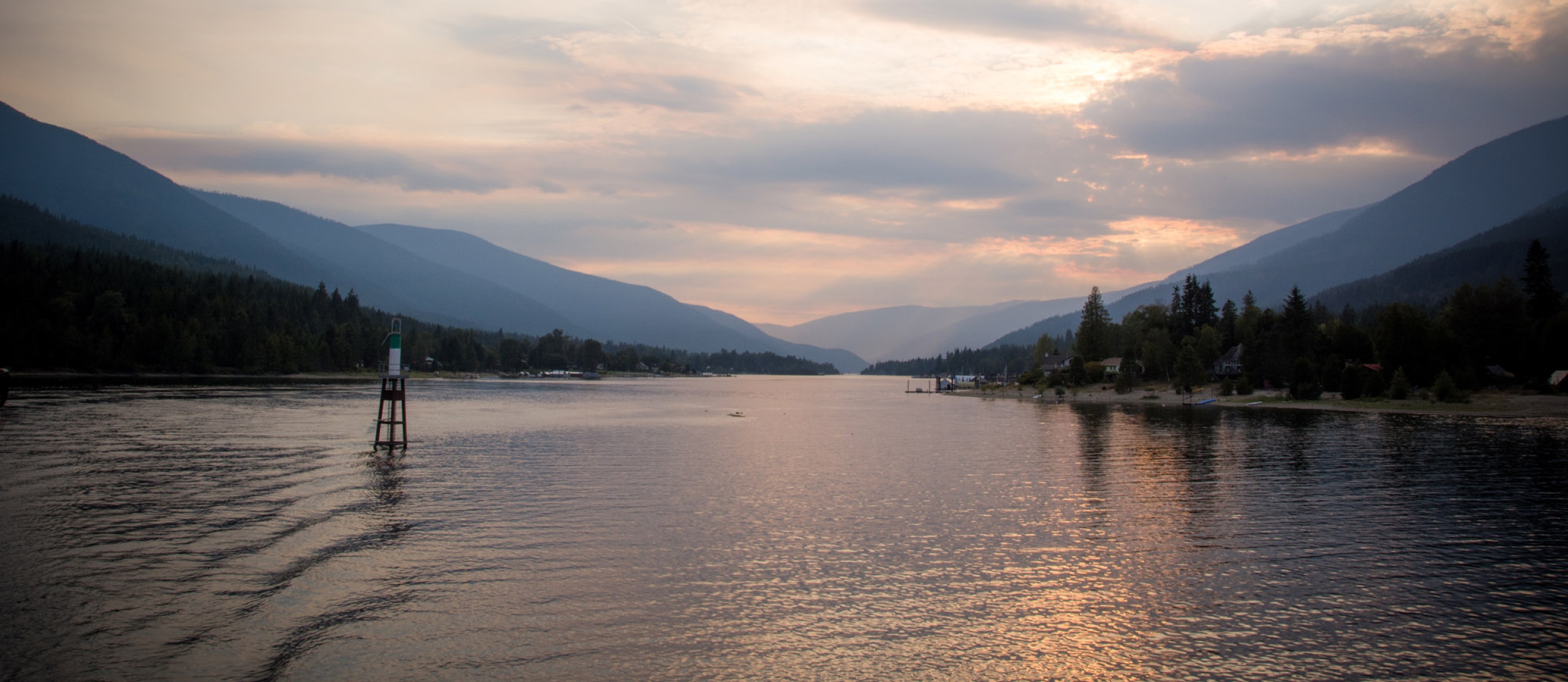 The sun starting to set on Kootenay Lake. View from the Kootenay Lake Ferry just after leaving the Balfour Ferry Terminal