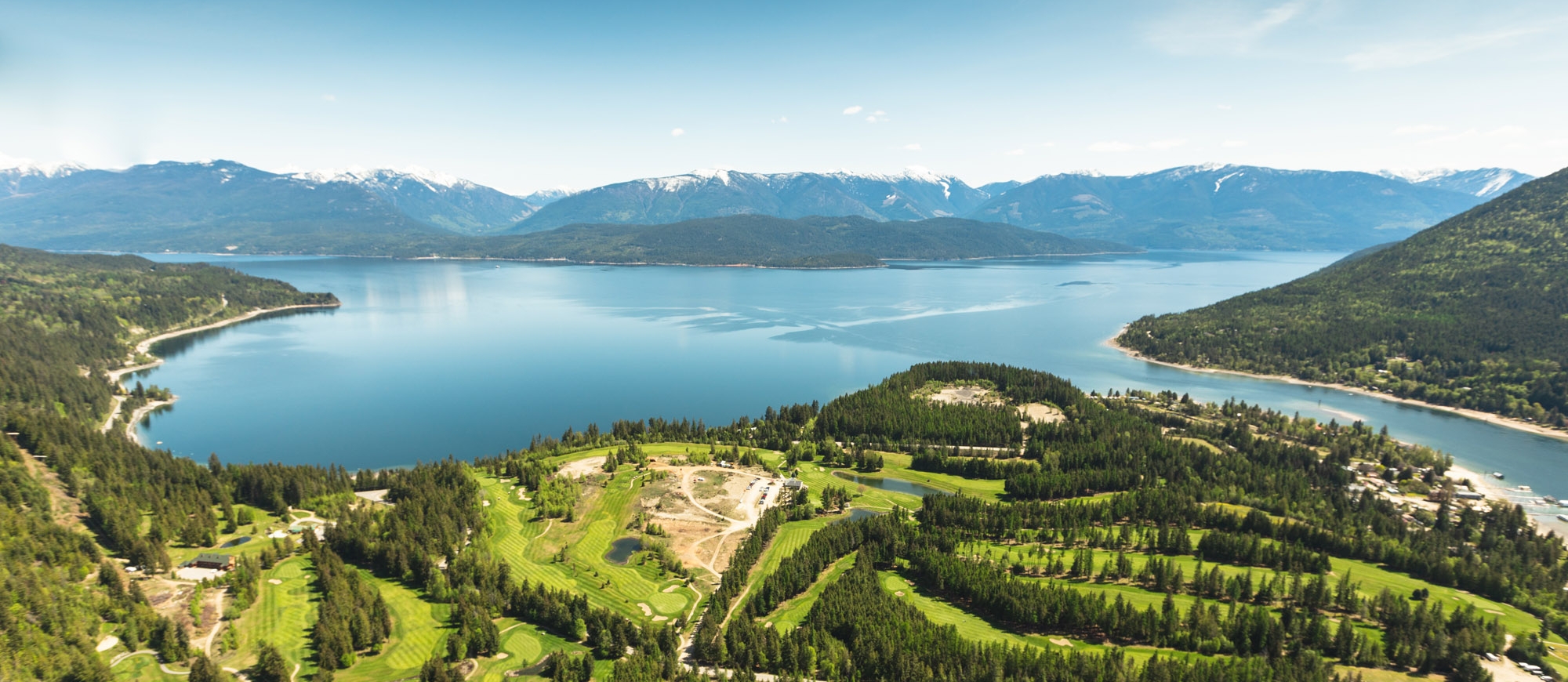 An aerial view of Balfour, BC, including Kootenay Lake and the golf courses.