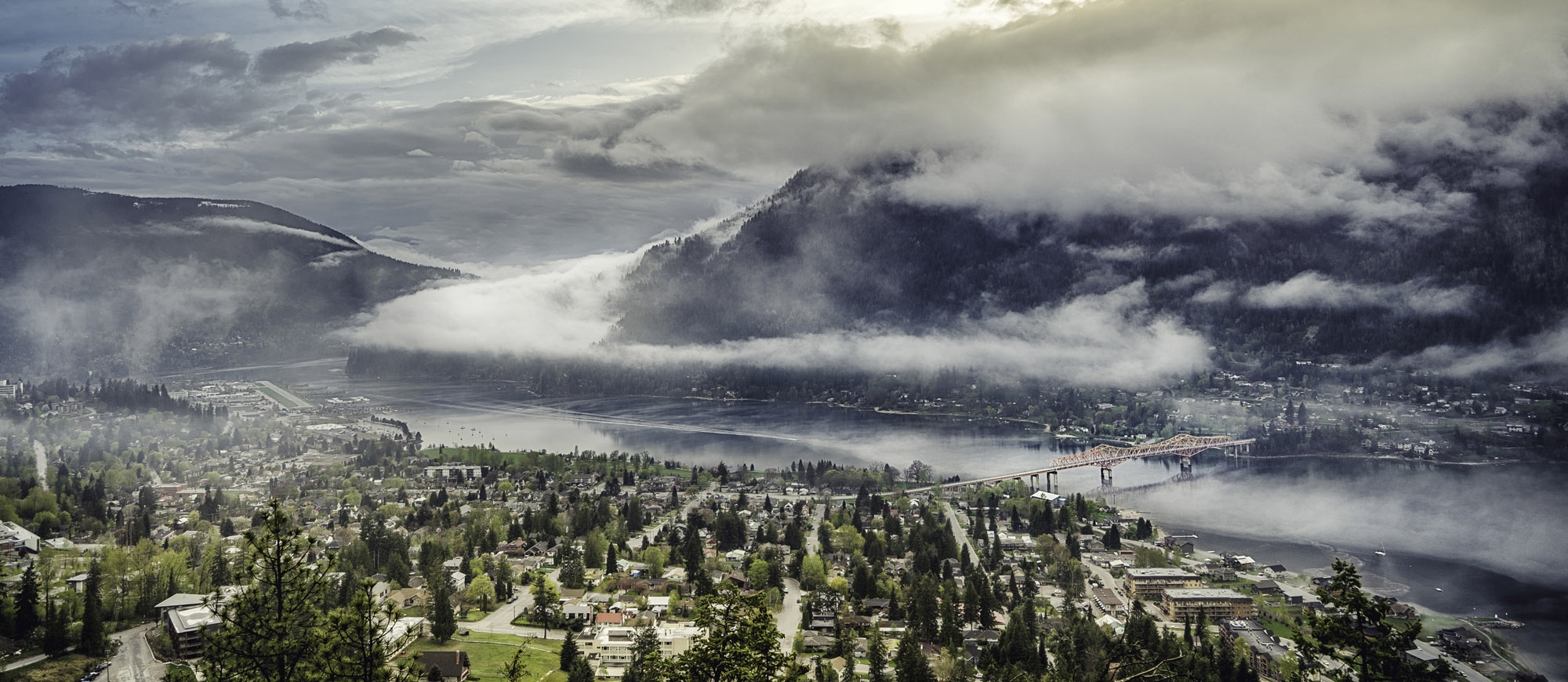 Aerial view of Nelson BC and Kootenay Lake with low hanging cloud.