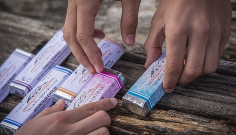 Hands reaching out for Chocofellar chocolate bars in Nelson BC.