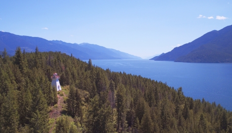 An aerial view of the Pilot Bay Lighthouse and Kootenay Lake, BC