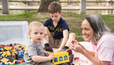 Childcare professional playing with children in Lakeside Park, Nelson BC.