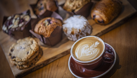 Coffee and muffins on a table.