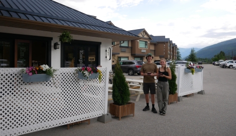 Baristas standing outside Empire Lakeside holding coffees.