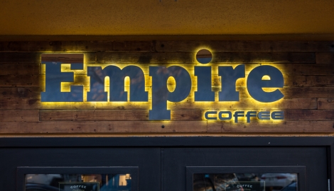 The Empire Coffee sign lit up on the outside of the building