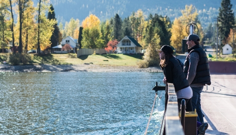 Three people standing on the Harrop Ferry taking in the views.