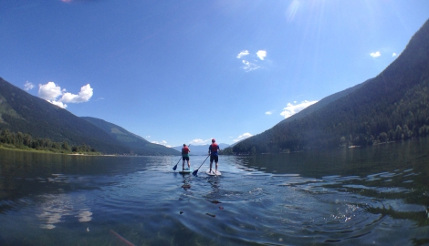 Two paddle boarder out front of Kokanee Creek Provincial Park.