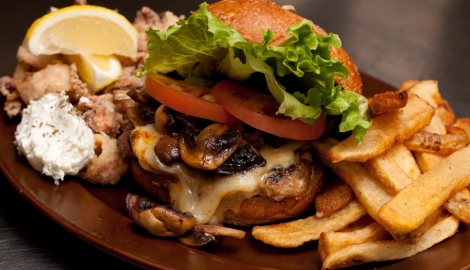 a burger with all of the fixings and fries on the side from Main Street Diner