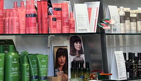 Hair products displayed on a shelf inside a salon.