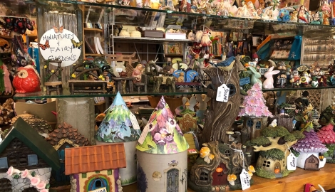 Trinkets, decorations and statues on a shelf at Through The Looking Glass