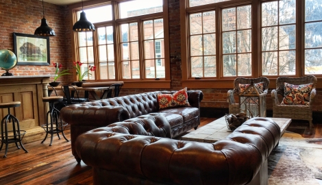 brown leather couches and large windows in the tremont loft 